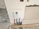 Installed tankless water heater with exposed pipes and wiring in the kitchen at 327 Frances Ter, Daytona Beach, FL 32118