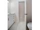 Bright bathroom featuring a white vanity with bronze hardware and neutral tile flooring at 3357 Black Willow Trl, Deland, FL 32724