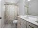 Bright bathroom with a white vanity, sink, mirror, and toilet with shower curtain at 3357 Black Willow Trl, Deland, FL 32724