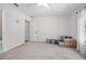 Carpeted bedroom with ceiling fan, boxes, and an entry leading to the bathroom at 3357 Black Willow Trl, Deland, FL 32724