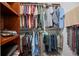 Spacious closet with built-in wooden shelves, hanging rods, and carpet, providing storage solutions at 3357 Black Willow Trl, Deland, FL 32724