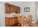 Dining area featuring a wet bar with wood cabinets and granite countertops at 3357 Black Willow Trl, Deland, FL 32724