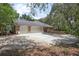 Brick home exterior featuring a three-car garage and well-maintained driveway at 3357 Black Willow Trl, Deland, FL 32724