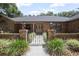 Charming brick home entrance with wrought iron gate and manicured landscaping at 3357 Black Willow Trl, Deland, FL 32724