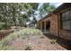 Charming brick home featuring a landscaped front yard with mature trees and a welcoming porch at 3357 Black Willow Trl, Deland, FL 32724