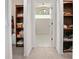 Hallway with linen closet leading to a bathroom with glass block window at 3357 Black Willow Trl, Deland, FL 32724