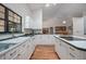 Bright kitchen with white cabinets, modern appliances, and a view into the dining area at 3357 Black Willow Trl, Deland, FL 32724