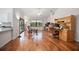 Open-concept living area with wood floors, a desk, and a sliding glass door at 3357 Black Willow Trl, Deland, FL 32724