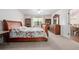 Bedroom with wooden furniture and a floral patterned bedspread at 3357 Black Willow Trl, Deland, FL 32724