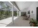 Spacious screened patio with tile flooring and seating area, perfect for outdoor relaxation at 3357 Black Willow Trl, Deland, FL 32724