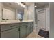 Stylish bathroom with gray cabinetry, quartz countertops, and modern fixtures offers both beauty and functionality at 348 Southern Winds Blvd, Deland, FL 32720