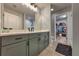 Beautiful bathroom with gray cabinets, quartz counters, and an open doorway to walk-in closet at 348 Southern Winds Blvd, Deland, FL 32720
