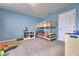 Bedroom features bunkbeds, a white shelving unit, and blue walls at 348 Southern Winds Blvd, Deland, FL 32720