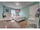 Bright bedroom featuring light-green walls, a bed, and toys at 348 Southern Winds Blvd, Deland, FL 32720