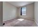 Neutral-toned bedroom with a window letting in natural light at 348 Southern Winds Blvd, Deland, FL 32720