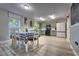Well-lit eat-in kitchen with modern appliances, wood flooring, and a dining area with a checkered tablecloth at 348 Southern Winds Blvd, Deland, FL 32720