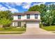 Charming two-story home with a well-manicured lawn, two-car garage and inviting curb appeal at 348 Southern Winds Blvd, Deland, FL 32720