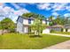 Corner view of a two-story home featuring a lush green lawn, and well maintained landscaping at 348 Southern Winds Blvd, Deland, FL 32720