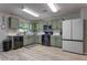Charming kitchen featuring sage-green cabinets, modern appliances, and a bright, welcoming atmosphere at 348 Southern Winds Blvd, Deland, FL 32720