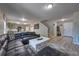 Inviting living room open to the kitchen with modern decor, open staircase and comfortable sectional seating at 348 Southern Winds Blvd, Deland, FL 32720