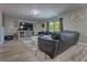 Bright living room features a comfy sectional sofa, media center, and natural light from the window at 348 Southern Winds Blvd, Deland, FL 32720