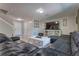 Spacious living room features a large, comfortable leather sectional, a fireplace, and plenty of seating at 348 Southern Winds Blvd, Deland, FL 32720