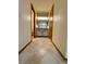 Hallway leading to bathroom featuring vanity, mirror, and lighting, showcasing a bright and functional space at 37 Meadowwood Trl, Deland, FL 32724