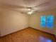 Inviting bedroom with hardwood floors, ceiling fan, and window providing natural light at 37 Meadowwood Trl, Deland, FL 32724