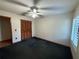 Cozy bedroom featuring a ceiling fan, shutters, and a closet with folding doors at 37 Meadowwood Trl, Deland, FL 32724