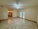 The tiled space with French doors, fan, and bathroom access blends indoor comfort with outdoor appeal at 37 Meadowwood Trl, Deland, FL 32724