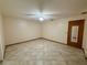 Spacious room with neutral walls and tile flooring, lit by a ceiling fan, creates a versatile space at 37 Meadowwood Trl, Deland, FL 32724