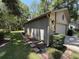 Side exterior showcasing stone accents, landscaping, and a brick pathway at 37 Meadowwood Trl, Deland, FL 32724