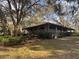 Charming home with a large covered porch, set amidst mature trees and lush landscaping for serene outdoor living at 37 Meadowwood Trl, Deland, FL 32724