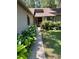 Inviting front walkway with lush, verdant plantings leading to front door at 37 Meadowwood Trl, Deland, FL 32724