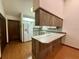 Bright kitchen showcasing white appliances, wood cabinetry, and an open layout perfect for entertaining guests at 37 Meadowwood Trl, Deland, FL 32724