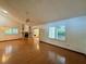 Spacious living room with wood floors, fireplace, vaulted ceilings, and plantation shutters at 37 Meadowwood Trl, Deland, FL 32724
