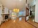 Spacious living room with wood floors, fireplace, vaulted ceilings, and a chandelier at 37 Meadowwood Trl, Deland, FL 32724
