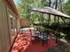Outdoor patio with umbrella, table and chairs set at 37 Meadowwood Trl, Deland, FL 32724