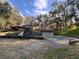 Community playground with play structure, basketball court, and surrounding trees at 37 Meadowwood Trl, Deland, FL 32724