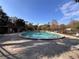 Relaxing pool surrounded by lounge chairs and mature trees, offering a perfect spot for leisure and recreation at 37 Meadowwood Trl, Deland, FL 32724