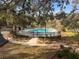 Secluded community pool nestled among mature trees, offering a private and tranquil retreat for residents at 37 Meadowwood Trl, Deland, FL 32724