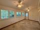 Sunroom with multiple windows and doors for natural light and outside views at 37 Meadowwood Trl, Deland, FL 32724