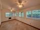 Sunroom with multiple windows and doors for natural light and outside views at 37 Meadowwood Trl, Deland, FL 32724