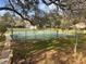Beautiful tennis courts nestled among mature trees, offering a perfect setting for exercise and recreation at 37 Meadowwood Trl, Deland, FL 32724