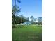 Exterior home with a large front yard, mature landscaping and bright-blue exterior at 3788 Fir Ct, Ormond Beach, FL 32174
