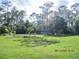 Exterior shot of property on large lot with tall trees at 3788 Fir Ct, Ormond Beach, FL 32174