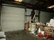 Garage interior with cluttered floor, storage, and roll-up doors at 3788 Fir Ct, Ormond Beach, FL 32174