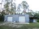 Metal building featuring two garage doors for parking or storage at 3788 Fir Ct, Ormond Beach, FL 32174