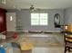 Spacious living room featuring tile floors, a ceiling fan, and a large window at 3788 Fir Ct, Ormond Beach, FL 32174