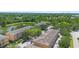 Aerial view of townhome complex with mature trees, and tranquil pond views at 4297 Regal Town Ln, Lake Mary, FL 32746